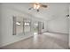Bright living room with neutral tile flooring, large windows, and a sliding glass door to let in natural light at 8904 Evening Star Dr, Las Vegas, NV 89134
