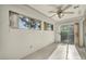 Bright room with a ceiling fan and large windows looking out to the yard at 8904 Evening Star Dr, Las Vegas, NV 89134