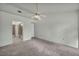 Spacious main bedroom featuring neutral carpet, ceiling fan, closet and adjacent access to the main bath at 8904 Evening Star Dr, Las Vegas, NV 89134