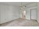 Spacious main bedroom with neutral carpet, ceiling fan and adjacent access to the main bath at 8904 Evening Star Dr, Las Vegas, NV 89134
