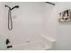 Bathroom featuring a white bathtub, black fixtures, white subway tile, and a neutral wall color at 900 Heavenly Hills Ct # 112, Las Vegas, NV 89145