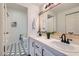 Bathroom with double sinks, a vanity, a bathtub, and patterned floors at 900 Heavenly Hills Ct # 112, Las Vegas, NV 89145