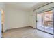 Spacious bedroom featuring white walls, hardwood floors, and sliding glass doors to a patio at 900 Heavenly Hills Ct # 112, Las Vegas, NV 89145