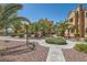 Exterior view of community landscaping with mature palm trees and walkways at 900 Heavenly Hills Ct # 112, Las Vegas, NV 89145