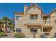 Condo building with a stucco exterior, and a well-kept landscape at 900 Heavenly Hills Ct # 112, Las Vegas, NV 89145