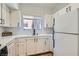 Clean kitchen with white cabinetry, and modern black appliances with a view from the window at 900 Heavenly Hills Ct # 112, Las Vegas, NV 89145