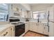 Well-lit kitchen with white cabinetry, modern appliances, and a window overlooking the exterior at 900 Heavenly Hills Ct # 112, Las Vegas, NV 89145