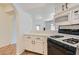Modern kitchen with white cabinets, tile countertops, and stainless steel appliances at 900 Heavenly Hills Ct # 112, Las Vegas, NV 89145