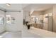 Open concept living room and kitchen featuring abundant light, light hardwood floors, and a kitchen bar at 900 Heavenly Hills Ct # 112, Las Vegas, NV 89145