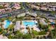 Aerial view showcasing pools, lush landscaping, and community amenities within a serene community of single-Gathering homes at 9077 Creed Mountain Pl, Las Vegas, NV 89178