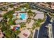 Aerial view of community recreation area featuring multiple pools, playground, basketball court, and picnic areas amid lush landscaping at 9077 Creed Mountain Pl, Las Vegas, NV 89178