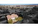 A high, wide aerial view of a vibrant neighborhood with tree-lined streets and charming homes nestled in a desert landscape at 9077 Creed Mountain Pl, Las Vegas, NV 89178