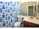 Bathroom featuring a shower-tub combo with a patterned shower curtain, and a single sink vanity at 9077 Creed Mountain Pl, Las Vegas, NV 89178