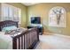Relaxing bedroom with natural light, neutral walls, and a wall-mounted TV for comfortable viewing at 9077 Creed Mountain Pl, Las Vegas, NV 89178