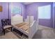 Unfurnished bedroom with light purple walls, a four poster bed frame, and large window at 9077 Creed Mountain Pl, Las Vegas, NV 89178