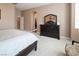 Primary bedroom features neutral walls, carpet flooring, walk-in closet, and dark wood furniture at 9077 Creed Mountain Pl, Las Vegas, NV 89178