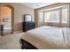 Primary bedroom features neutral walls, carpet flooring, window, and dark wood furniture at 9077 Creed Mountain Pl, Las Vegas, NV 89178