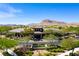 Beautiful clubhouse exterior showcasing desert landscaping, stone accents, and a welcoming entrance in a serene setting at 9077 Creed Mountain Pl, Las Vegas, NV 89178