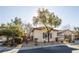 Street view of a cozy house with mature trees and an inviting curb appeal at 9077 Creed Mountain Pl, Las Vegas, NV 89178