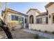 Close up of the front entrance with desert landscaping and an arched doorway at 9077 Creed Mountain Pl, Las Vegas, NV 89178
