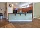 Kitchen featuring dark wood cabinetry, tile flooring, and black appliances at 9077 Creed Mountain Pl, Las Vegas, NV 89178