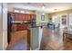 Open kitchen featuring granite counters, dark wood cabinetry, tile flooring, and stainless steel appliances at 9077 Creed Mountain Pl, Las Vegas, NV 89178