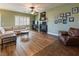 Spacious living room with a fireplace, fan, and hardwood flooring at 9077 Creed Mountain Pl, Las Vegas, NV 89178