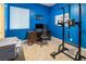 Bright blue office with a modern desk, pull-up bar, and ample space for work and fitness at 9077 Creed Mountain Pl, Las Vegas, NV 89178