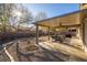 Covered patio with outdoor seating, perfect for entertaining in the landscaped backyard at 9077 Creed Mountain Pl, Las Vegas, NV 89178