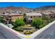 Community features two-story homes, desert landscape and mountainous backdrop at 917 Pomander Point Pl, Henderson, NV 89012