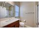 Bright bathroom features a modern vanity, neutral tones, and a glass-enclosed shower at 917 Pomander Point Pl, Henderson, NV 89012