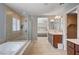 Beautiful bathroom featuring a tub, glass shower, and views into the main bedroom at 917 Pomander Point Pl, Henderson, NV 89012