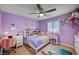 Purple bedroom with a ceiling fan, a desk, and mermaid themed bedding and decor at 917 Pomander Point Pl, Henderson, NV 89012