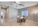 Bright dining area with hardwood floors, neutral walls, modern ceiling fan, and natural light for peaceful meals at 917 Pomander Point Pl, Henderson, NV 89012