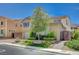 Two-story home with front yard landscaping, a brick trimmed garden and driveway at 917 Pomander Point Pl, Henderson, NV 89012