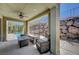 Covered patio with comfortable seating, a view of the pool, and a rock feature at 917 Pomander Point Pl, Henderson, NV 89012