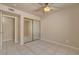 Bedroom featuring neutral walls, tiled floors, ceiling fan and a mirrored closet at 9325 W Desert Inn Rd # 143, Las Vegas, NV 89117