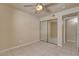 Bedroom featuring neutral walls, tiled floors, ceiling fan and a mirrored closet at 9325 W Desert Inn Rd # 143, Las Vegas, NV 89117