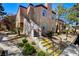 Inviting two-story condo with well-maintained landscaping and stairs leading to the front entrance at 9325 W Desert Inn Rd # 143, Las Vegas, NV 89117