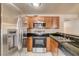 Kitchen with stainless steel appliances, granite countertops and wood cabinets at 9325 W Desert Inn Rd # 143, Las Vegas, NV 89117