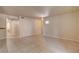 Spacious living room with neutral tile flooring, fresh paint, and ample natural light from windows at 9325 W Desert Inn Rd # 143, Las Vegas, NV 89117