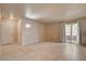 Spacious living room with neutral tile flooring, fresh paint, and sliding door for easy outdoor access at 9325 W Desert Inn Rd # 143, Las Vegas, NV 89117