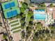 Aerial view showcases the community pool, tennis and bocce ball courts, and landscaping, creating a vibrant recreational space at 9445 Grand Mesa Dr, Las Vegas, NV 89134