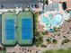 Aerial view highlighting tennis courts, a parking lot, and a resort-style pool area with lounge chairs at 9445 Grand Mesa Dr, Las Vegas, NV 89134