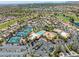 Extensive aerial view reveals community tennis courts, pools, and clubhouse nestled among lush landscaping and residential areas at 9445 Grand Mesa Dr, Las Vegas, NV 89134
