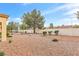 Spacious backyard with desert landscaping, mature trees, and privacy fencing for peaceful enjoyment at 9445 Grand Mesa Dr, Las Vegas, NV 89134