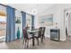 Elegant dining room with modern light fixture, ocean-themed painting and a wine refrigerator at 9445 Grand Mesa Dr, Las Vegas, NV 89134