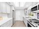 Modern kitchen featuring stainless steel appliances, quartz countertops, and a skylight at 9445 Grand Mesa Dr, Las Vegas, NV 89134