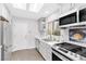 Modern kitchen boasting stainless steel appliances, white cabinets, and skylight at 9445 Grand Mesa Dr, Las Vegas, NV 89134