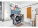 Functional laundry area with modern washer and dryer, shelving for storage, and utility connections at 9445 Grand Mesa Dr, Las Vegas, NV 89134